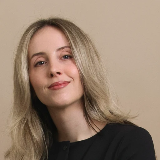 Portrait of Margaret Pieczkowski smiling against a warm beige backdrop
